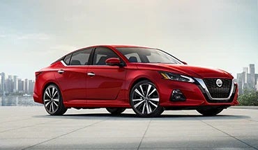 2023 Nissan Altima in red with city in background illustrating last year's 2022 model in Carlock Nissan of Jackson in Jackson TN