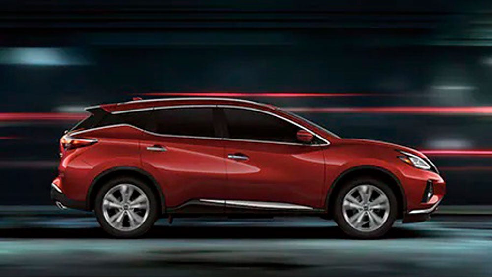 2023 Nissan Murano shown in profile driving down a street at night illustrating performance. | Carlock Nissan of Jackson in Jackson TN