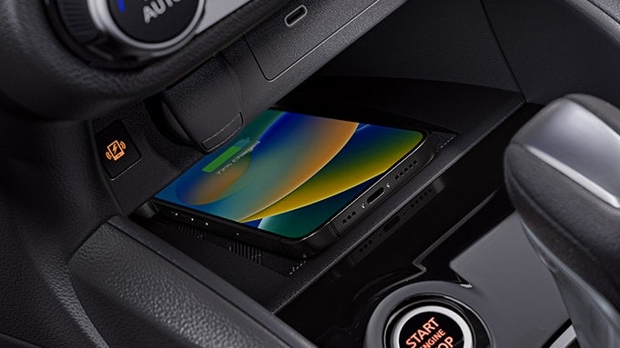 2024 Nissan Versa interior detail showing smartphone on wireless charger